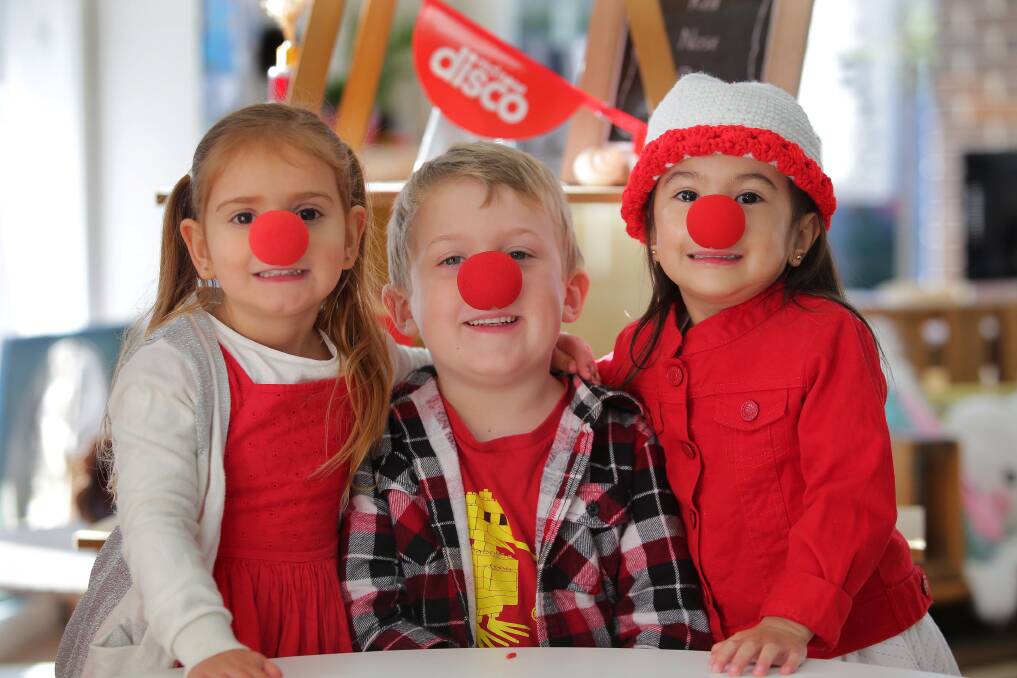 Red Nose Day: Angels of Alfred St Childcare children (from left) Camilla, 3, Sam, 3, and Chloe, 3, get ready for Red Nose Day. Picture: John Veage