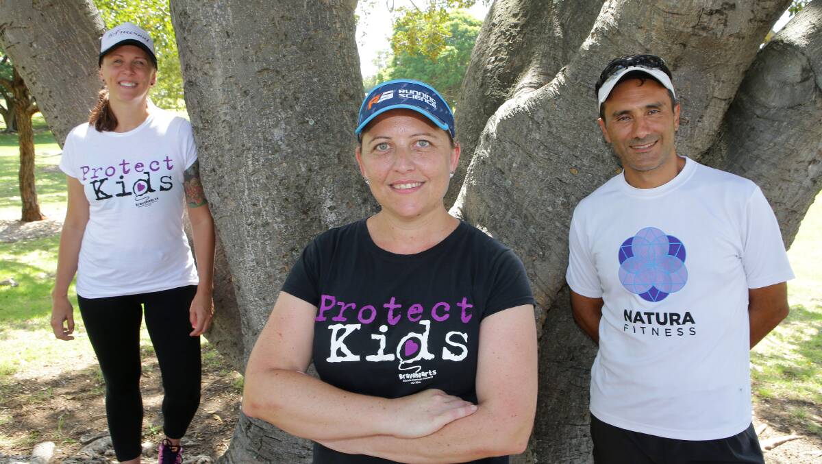 Gruelling: Belinda Boston (centre) pictured with team mate Sam McCauliffe (left), who is running seven half marathons, and running coach Victor Paciocco. Picture: John Veage