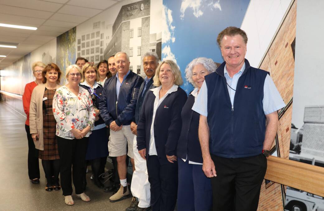 Corridor: Long-serving staff at St George Hospital pose in front of the new history wall. Picture: Supplied