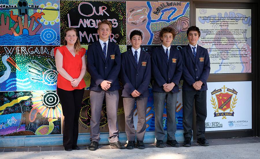 Display: De La Salle College Caringbah teacher Natasha Dalton with students (from left) Ben Hunton, Noah Fenech, Rivva Jory and Blake Fraser in front of their art work. Picture: Supplied