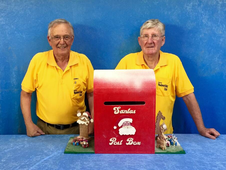 Santa: Shire Woodworking Club member Barry Gardner (left) and president Ian Rudd with the letter box. Picture: Supplied