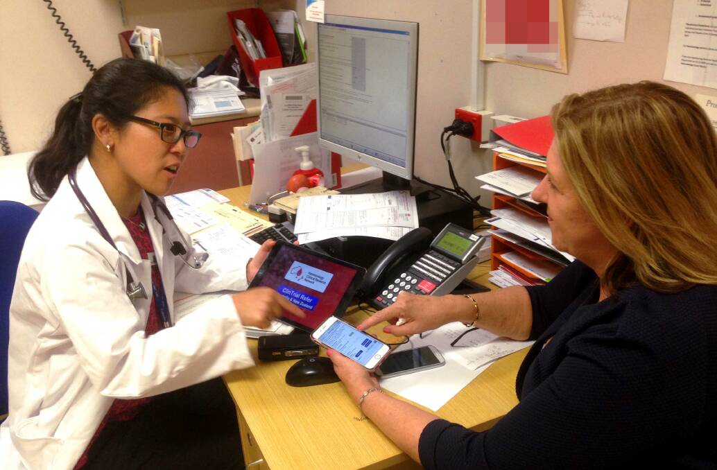 Recognised: St George Hospital clinical research unit manager Roslyn Ristuccia (right) explaining how to use the ClinTrial Refer app with Dr Shir-Jing Ho. Picture: Supplied
