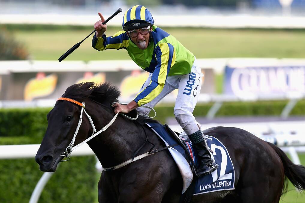 RIDING HIGH: Damien Oliver riding Lucia Valentina celebrates winning Race 9 in the Longines Queen Elizabeth Stakes during Queen Elizabeth Stakes Day at Royal Randwick. (Photo by Jason McCawley/Getty Images)
