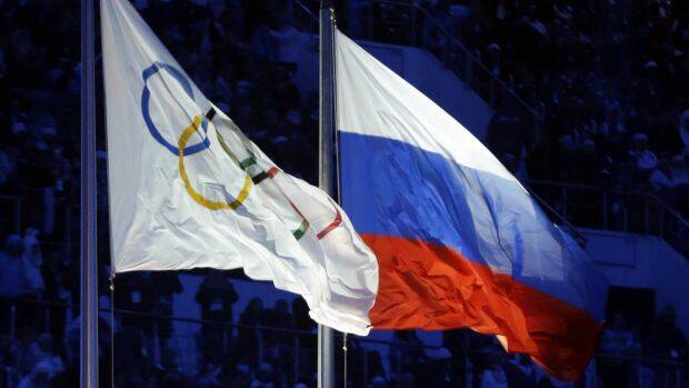 The Russian and Olympic flags fly at the Sochi winter Olympics, where medallists were involved in doping. Photo: AP