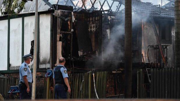 Police remain at the scene of a house fire on Paringa Place in Bangor. Photo: Peter Rae