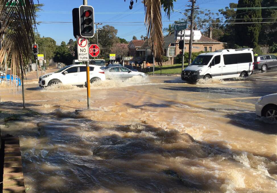Deluge: Drivers maneuver through water at the corner of King Georges Road and Hillcrest Avenue.