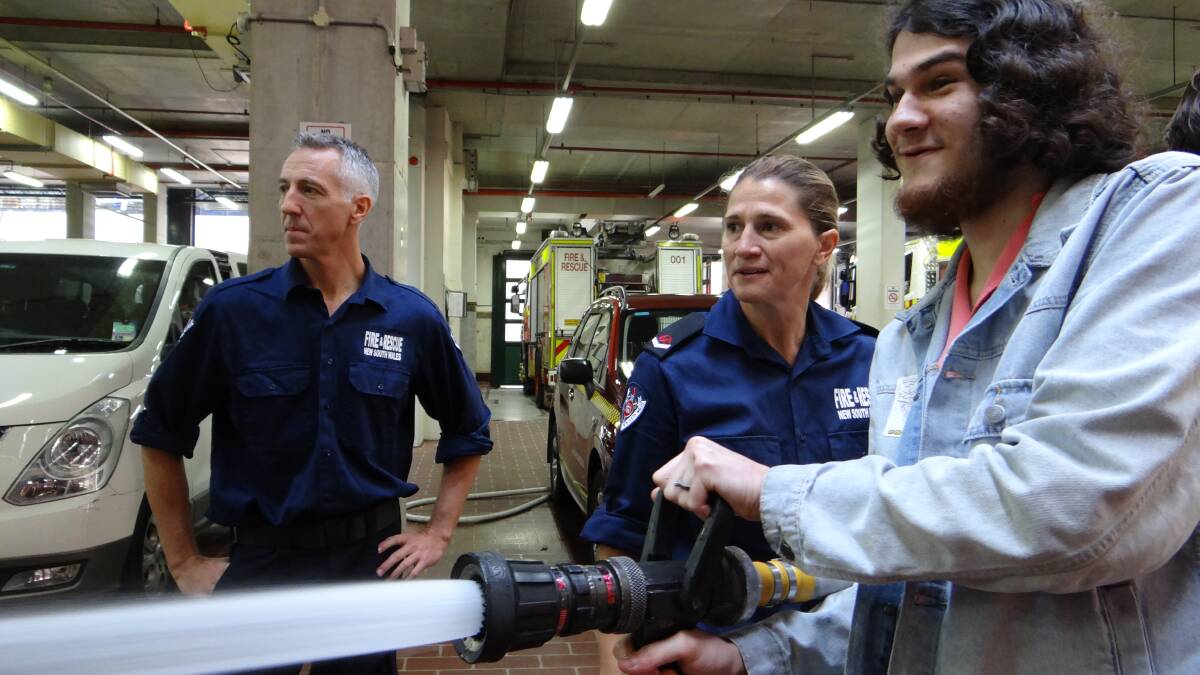 Hands on: Ronan Bryan tests out the fire equipment with Richard Evans and Michelle Sexton. Picture: Supplied