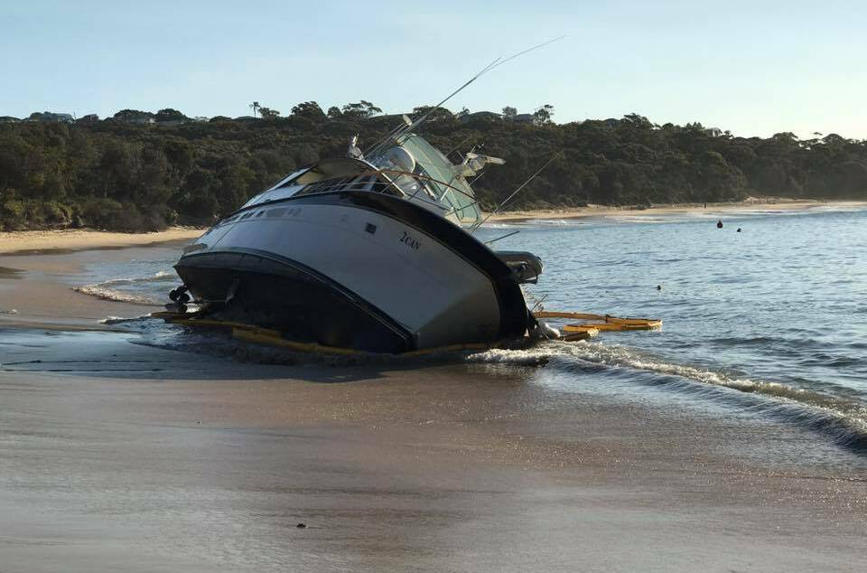 Beached: A large cruiser was left stranded on Jibbon Beach after it slipped its moorings. Picture: Bundeena Fire and Rescue