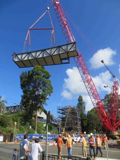 High rise: A crane moves a new walkway into place. Picture: Robin Robertson.