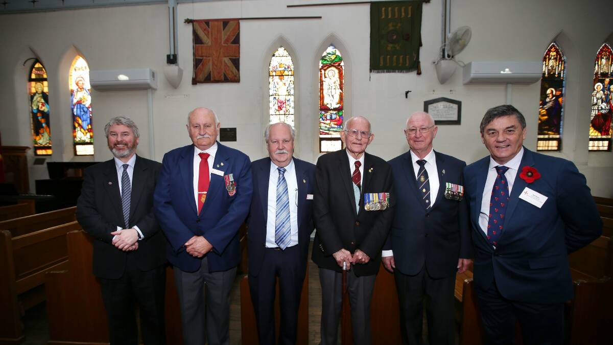 Honouring the fallen: Nick Fletcher, Brian Borland, John Thomas, Colonel Vin Halloran, Bob Mowle, Don Nelson and Will Davies. Picture: John Veage