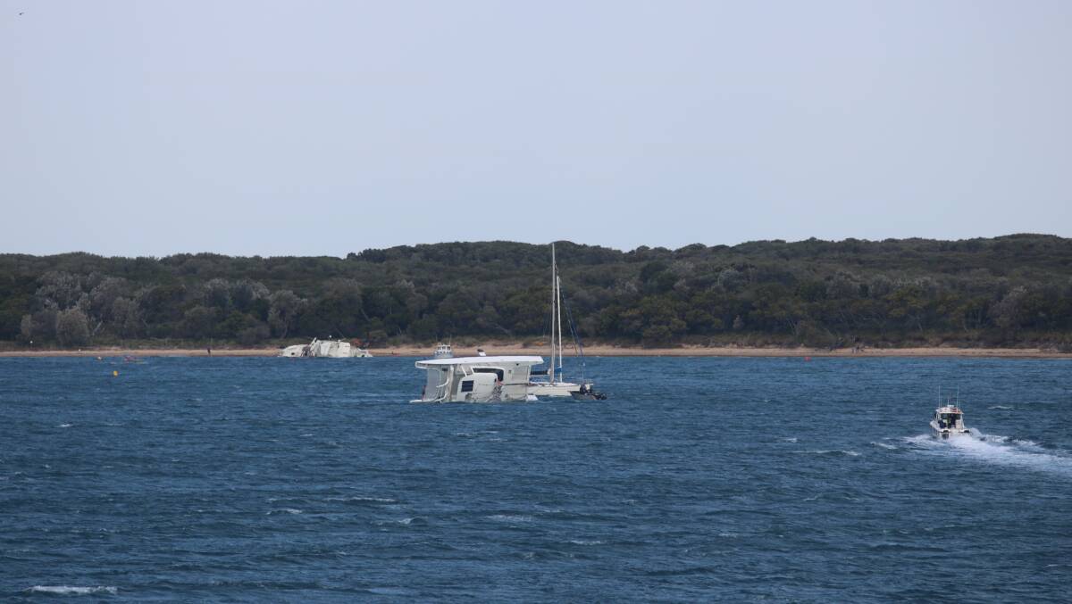 Rescue: A catamaran has flipped off Jibbon Beach on Wednesday. Picture: Marine Rescue NSW