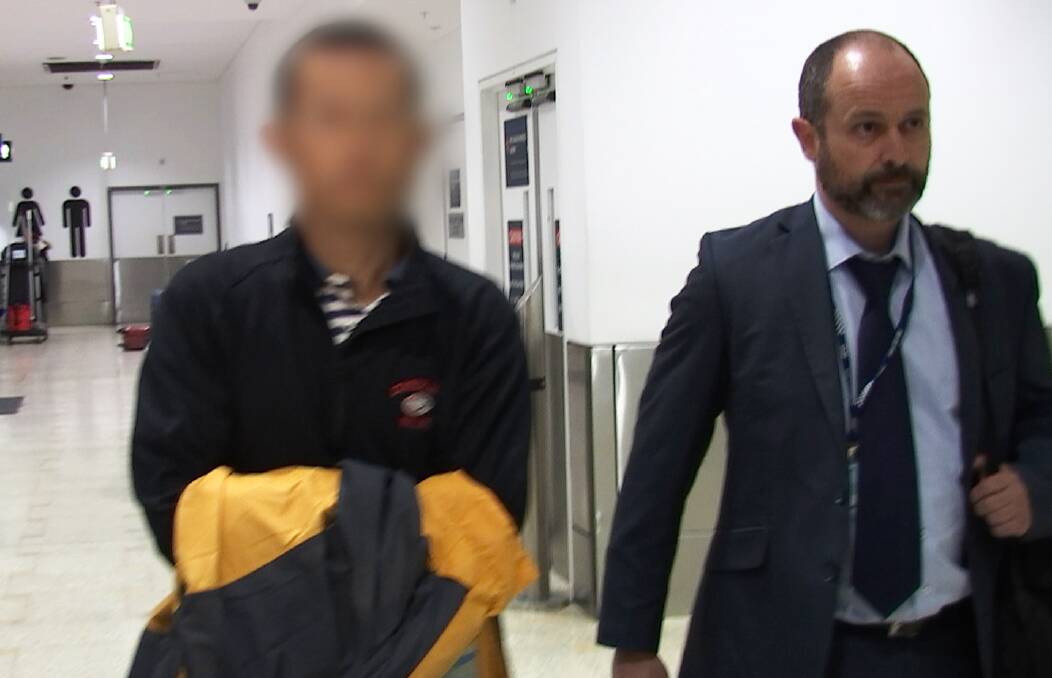 Arrest: Police escort a man from Sydney Airport after he was extradited from the UK on manslaughter charges: Picture: NSW Police