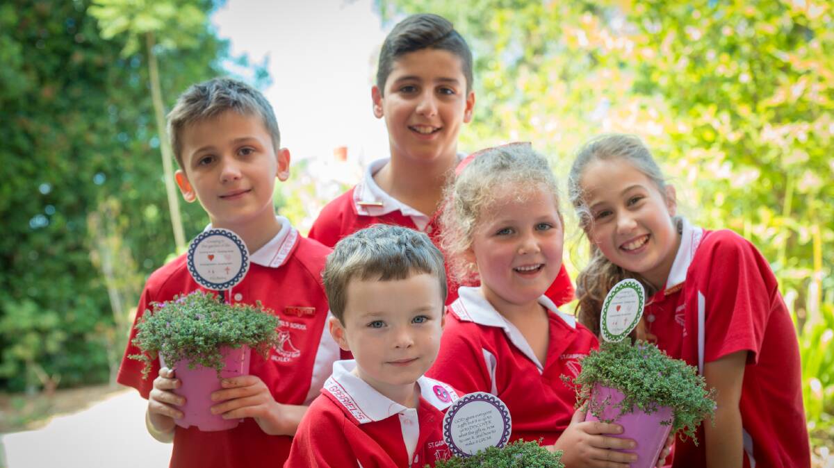Student grow to learn: Year 6 leaders Luke Gordon, Alexander D'Acunto and Gabrielle Burton, and Kindergarten students Amelia Gibbons and Thomas Nevin, with plants given to them to symbolise the school's GROW learning philosophy. Photo:Kitty Beale