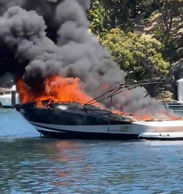 Flames: The boat on fire at Yowie Bay on Tuesday. Picture: Grays Point RFS on Facebook 