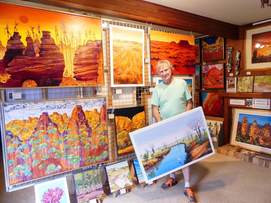 Bright display: Artist, Peter Mulder, with his paintings of the Kimberley region of Australia, titled 'Kimberley Calling'. Picture: Nicole Tinker