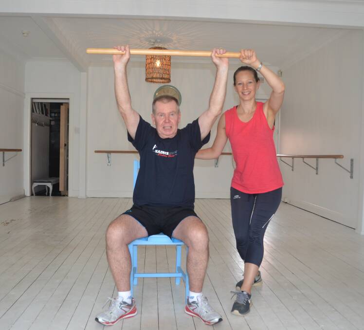 Stretching for strength: Occupational therapist Tamsin Phillips takes Oatley's David Laurence through his exercises.
