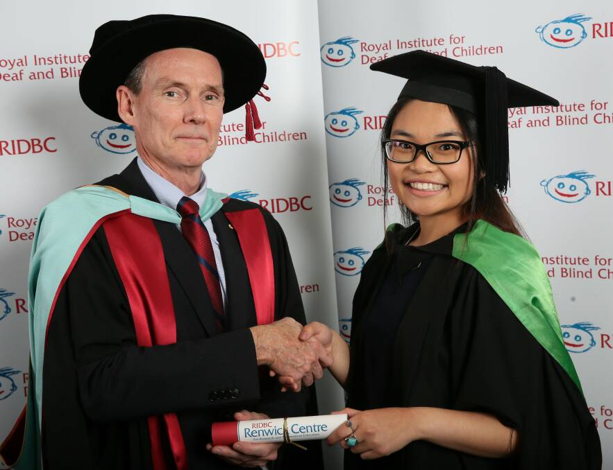 Educational achievement: Joyce Tan receives her testamur from Professor Greg Leigh.