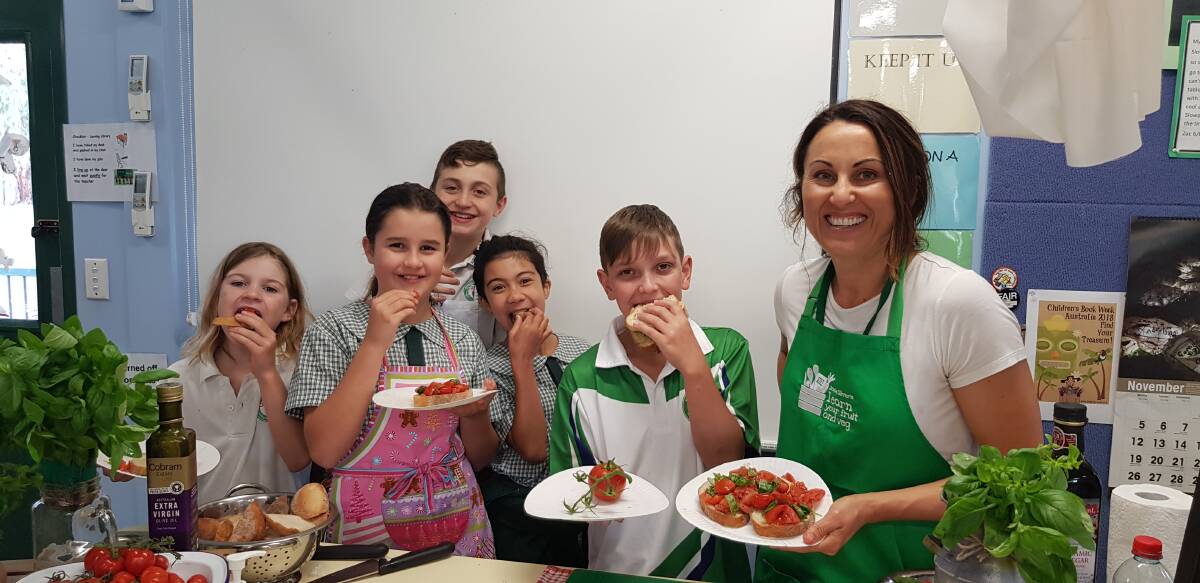 Recipes made fun and yum: A facilitator from The Good Food Foundation at the launch of Jamie Oliver's Learn Your Fruit and Veg program at Waterfall Public School.