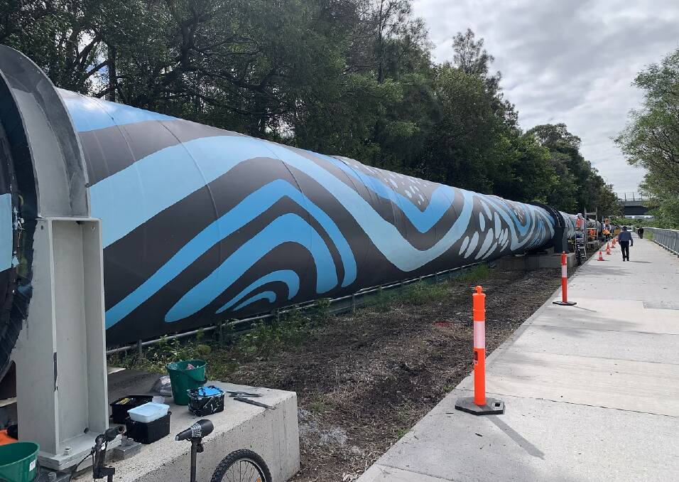 A graffiti-covered 800-metre pipeline at Tempe that carries millions of litres of drinking water from the Sydney Desalination Plant every day is being given a major face lift thanks to a First Nations-inspired artwork project. Picture supplied