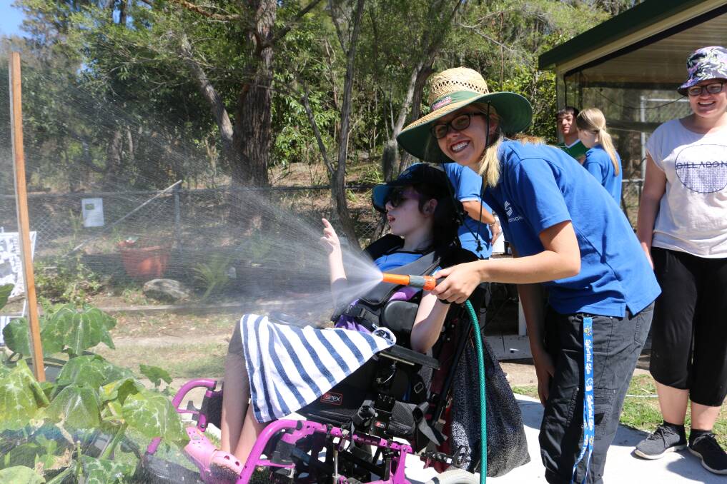 Fun in the sun: Sylvanvale staff show children how to look after the garden.
