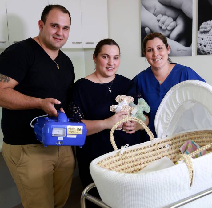 Gift: Dion and Chloe Stavlas, pictured with a staff member from St George Private Hospital's maternity ward, donated a Cuddle Cot to the hospital.