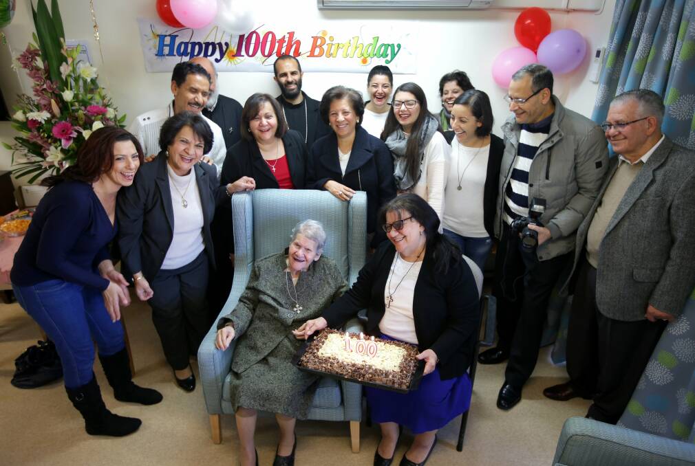Going strong: Malaka Nasr on her 100th birthday, surrounded by her family. Picture: John Veage