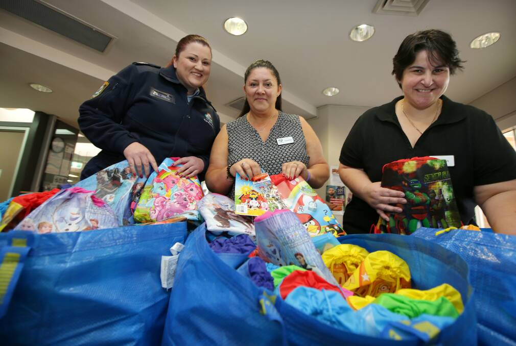 Packs of kindness: Danielle Lucas and Jan Klianis have donated more than 200 care packs to Miranda Police, to give to children from family tragedy or domestic violent situations. They are pictured with Kelly Donaghy of Miranda Police. Picture: John Veage