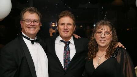 Pictured is former event supporter Rick Grossman from Hoodoo Gurus at the 2019 Child Protection Foundation Black Tie Masquerade Ball with Bruce and Kerry Fozzard, who established the charity. The event returns in 2024. Picture supplied