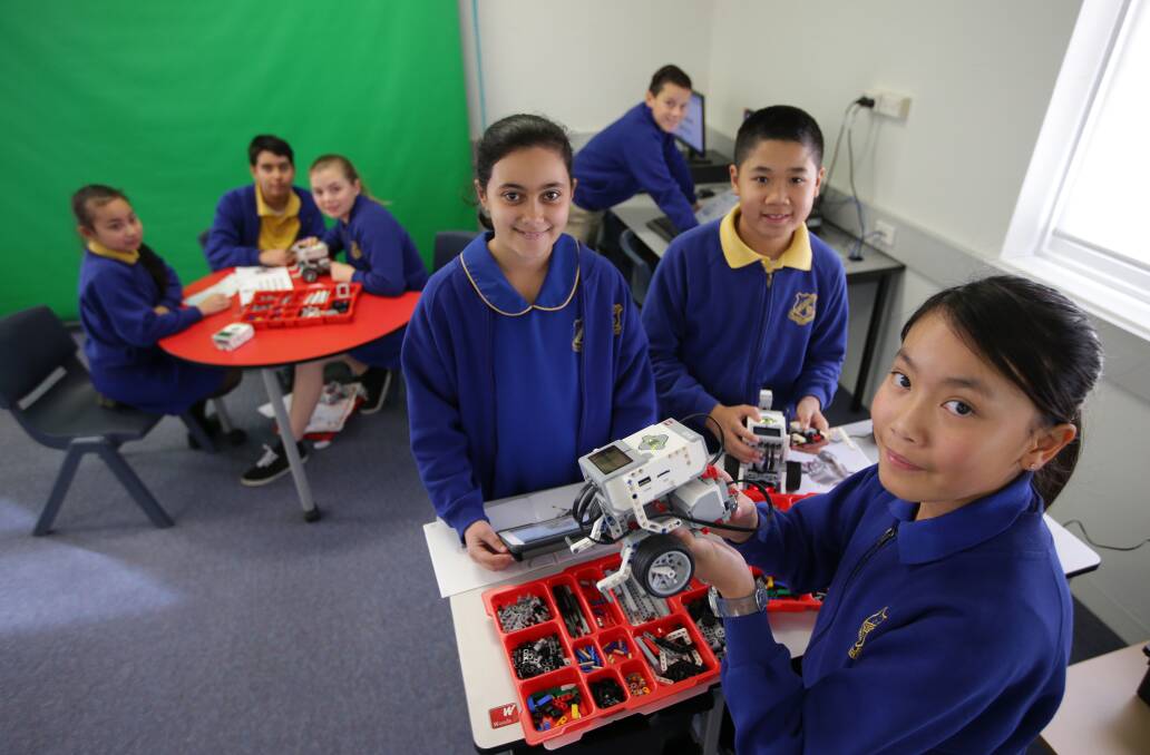 Robot ready: Kingsgrove Public School pupils YoYou, Demi, Vernon (front), Lisa, Samuel, Hannah and Marco mark Education Week with technology workshops. Picture: John Veage