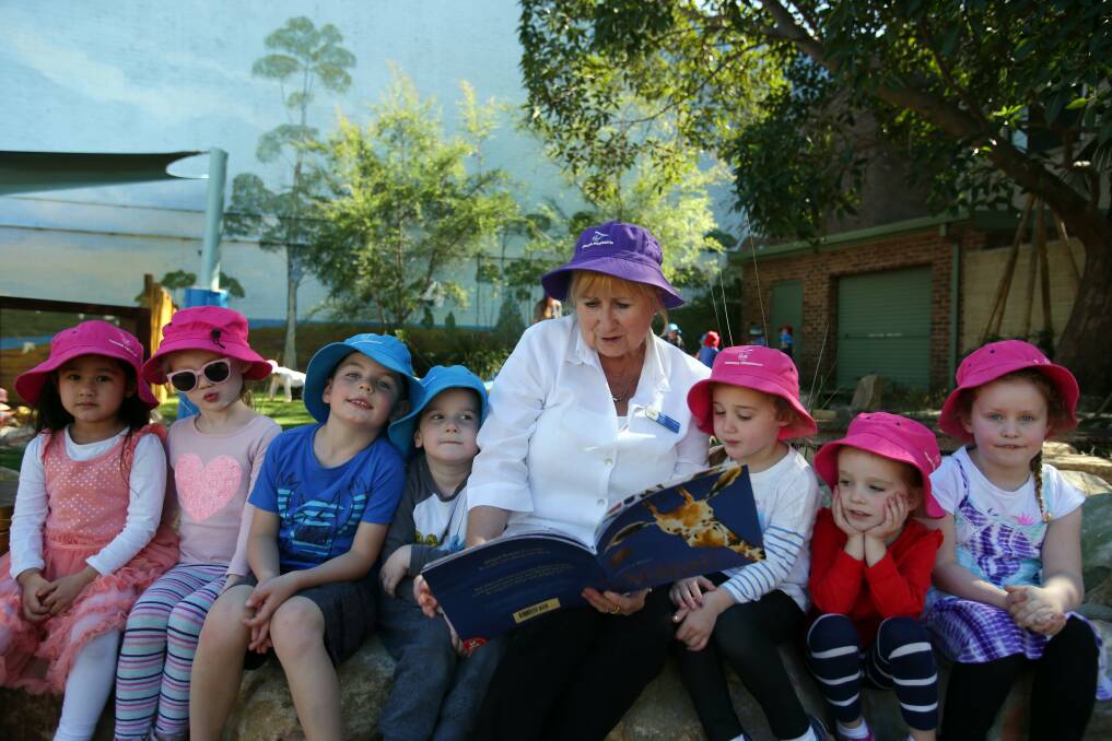 Kindy time: Engadine Preschool teacher Helen Douglas reads to children. Picture: Chris Lane