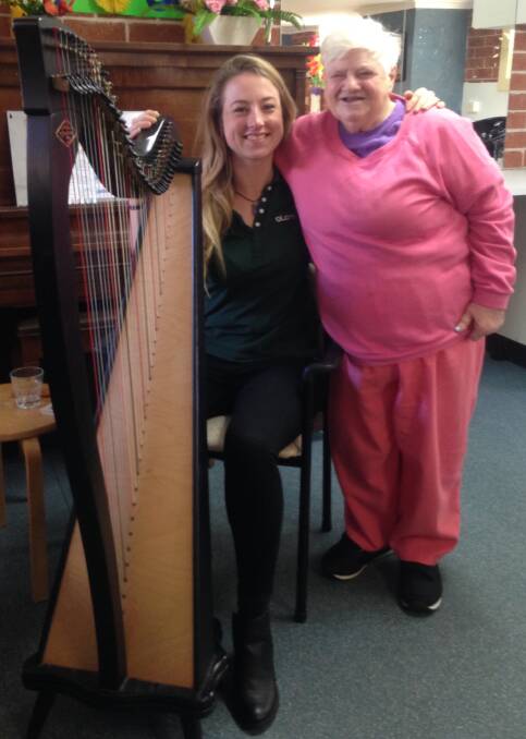 Happy strings: Harpist Chloe and resident Maureen, 70.