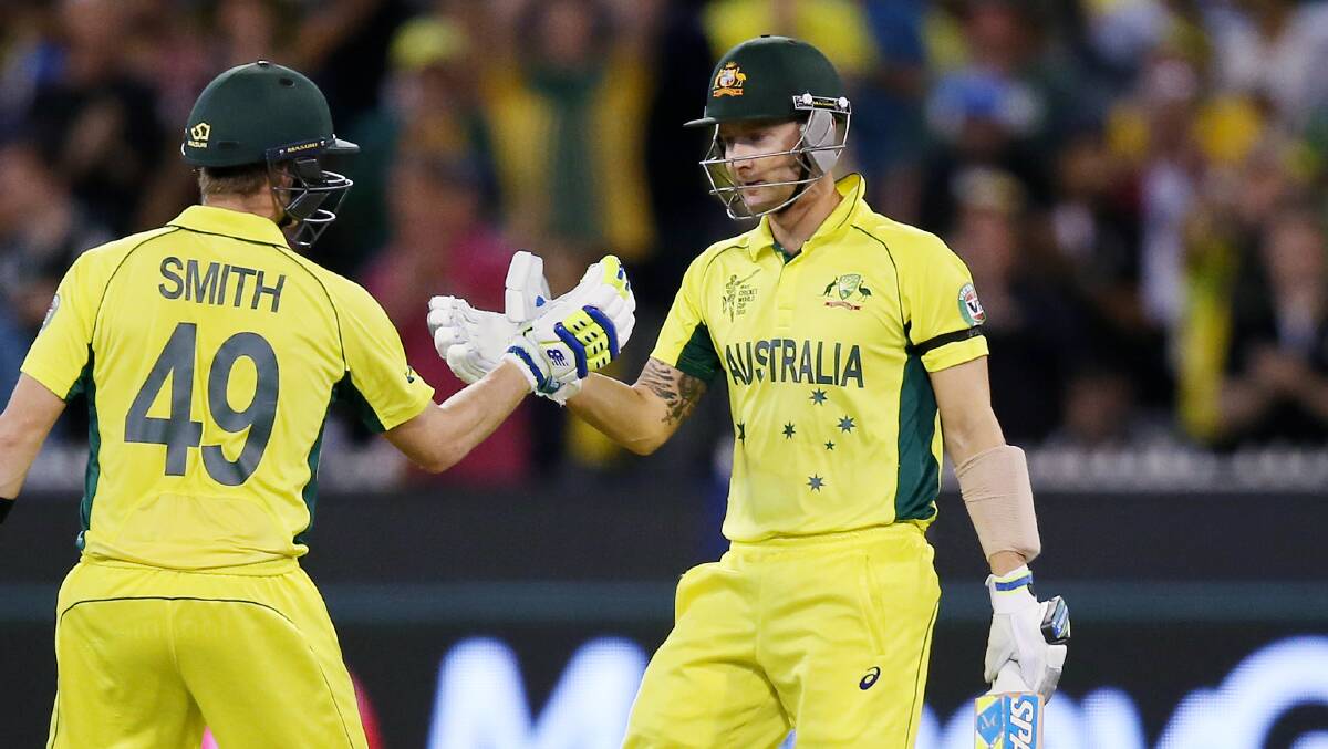 Past and present: Former Australian captain Michael Clarke (right) batting with Sutherland batsman and current Australian captain Steve Smith in the World Cup Final in Melbourne in 2015. Picture: AP Photo/Rick Rycroft