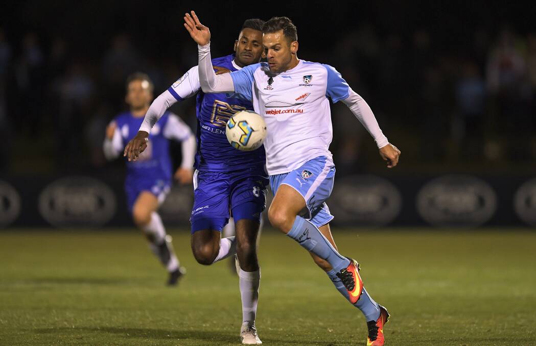 One to go: Bernard Rene and Bobo battle during the FFA Cup semi-final between Canberra Olympic and Sydney FC at Viking Park. Picture: Brett Hemmings/Getty Images