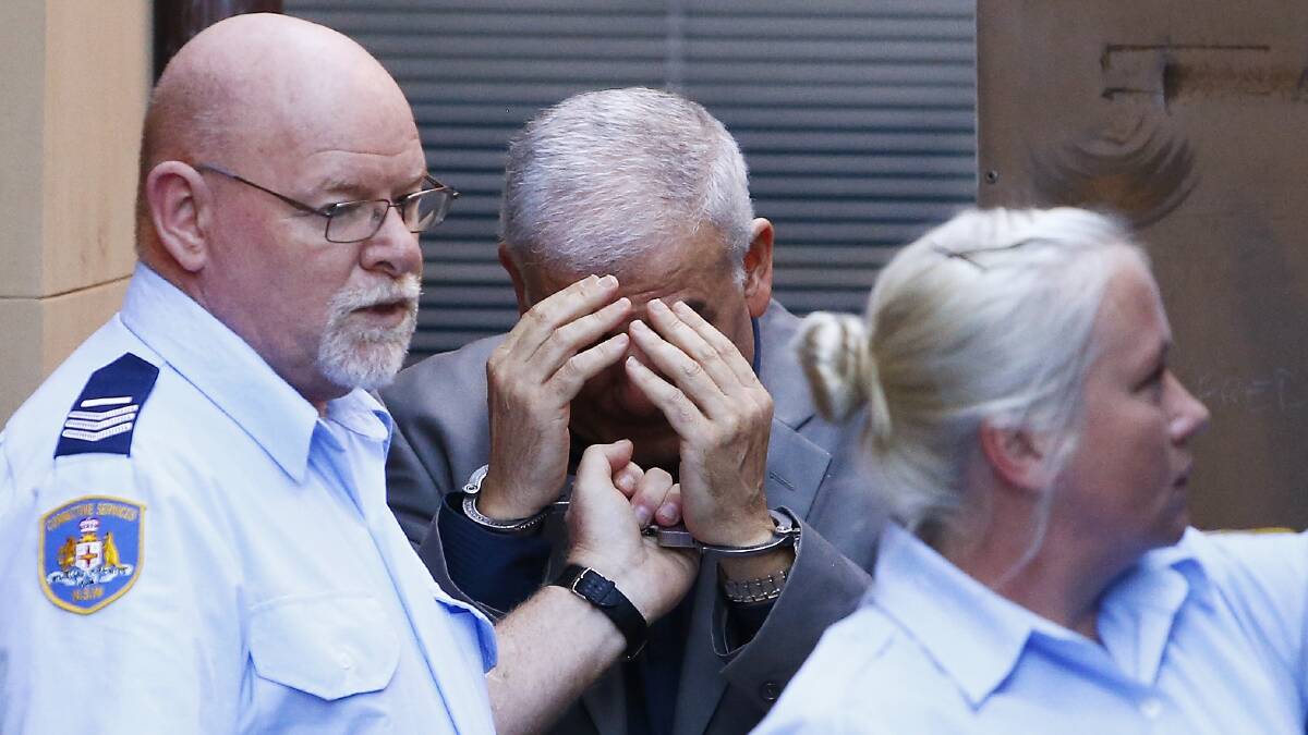 Arrest: Haydar Haydar is escorted to a prison truck at King Street Court on Tuesday. Picture: Daniel Munoz