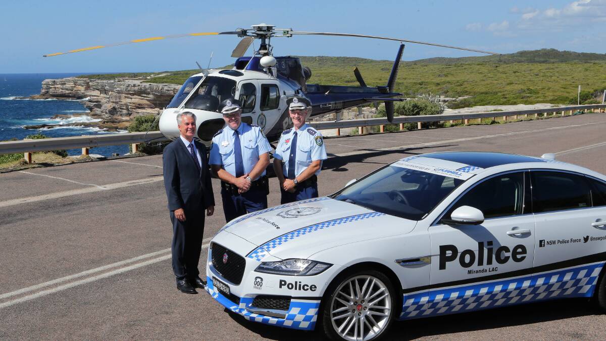 Hot ride: Rod Dale from Purnell Motors helps launch the new sponsored Jaguar XF with Miranda police Inspector Mick Merrett and Inspector Gary Ford. Picture:John Veage.
