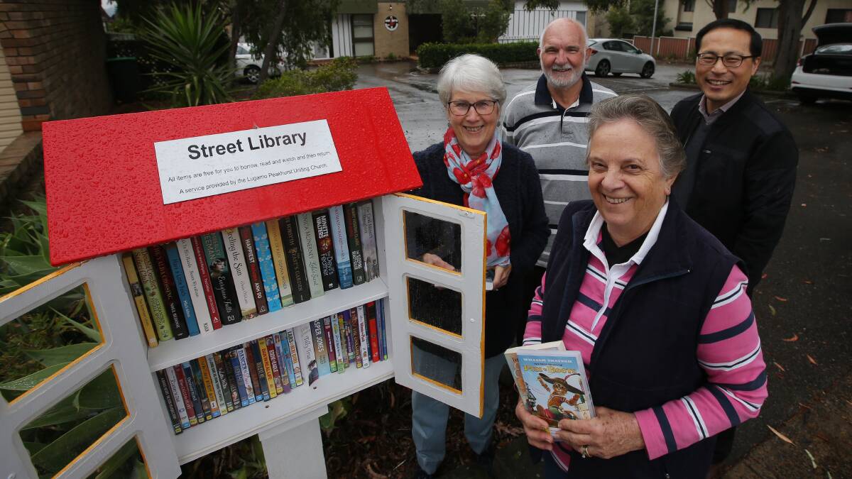 Page turner: Lyn Garrard, Pamela Hanna, Richard Hanna and Reverend Il-Wong Kim with the new street library at Lugarno. Picture: John Veage