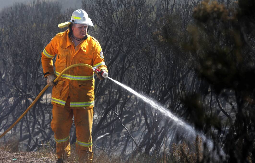 Fire ready: Rural Fire Service volunteers clean up after the Kurnell fire. Picture: John Veage