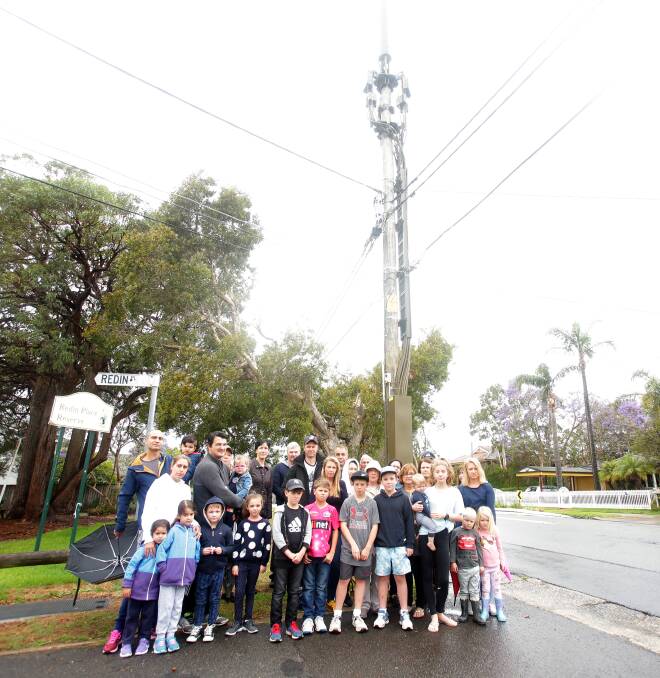 Towering concerns: Connells Point residents with the mobile phone base station which they say should not have been allowed in a residential area. Picture: Chris Lane
