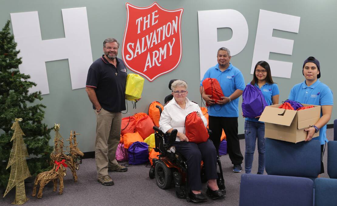 Christmas spirit: Salvation Army Rockdale Major Paul Kinder, Major Janet Siddons with St George and SUtherland Community College interns Aaron Khan, Abigail Medrano and Elwood Temple. Picture: John Veage