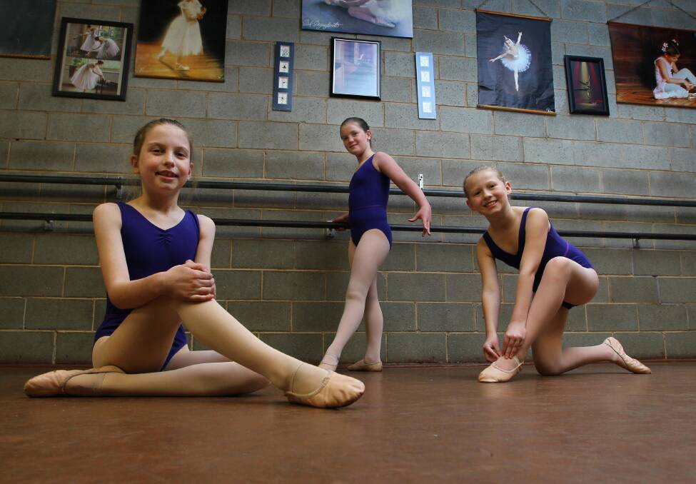 FORM AND GRACE: Dominique Timothy-Nesbitt, 9, Abbey Townsend, 11, and Chelsea Holle, 10, preparing for their fourth grade ballet exam. Photo: Les Smith