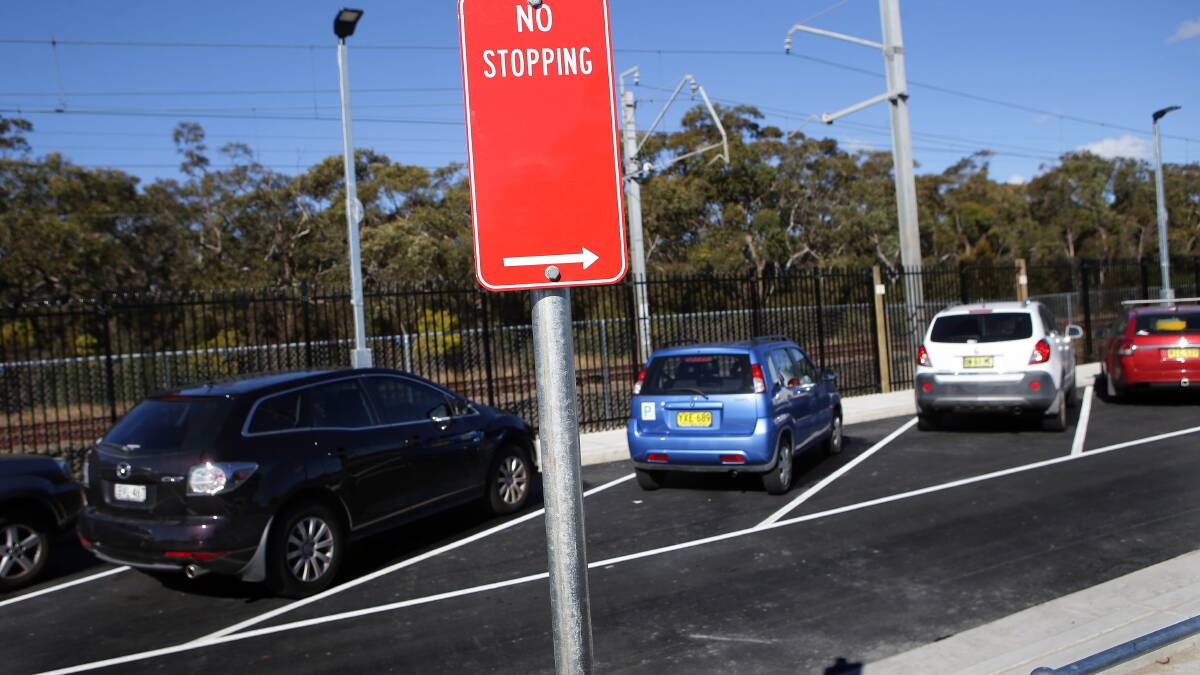Signs on the highway next to the new car park at Engadine station. Picture: John Veage