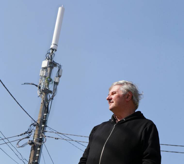 New trend: Bob Wood next to a base station at Connells Point, which is the first in the area to be located 10 metres from homes. Picture: John Veage