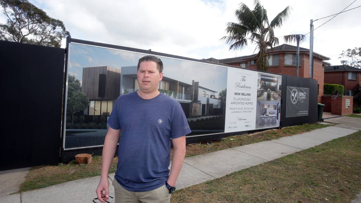 Adrian Hayward in front of the "offending'" advertising sign in Old Princes, Highway, Engadine. Picture: Chris Lane
