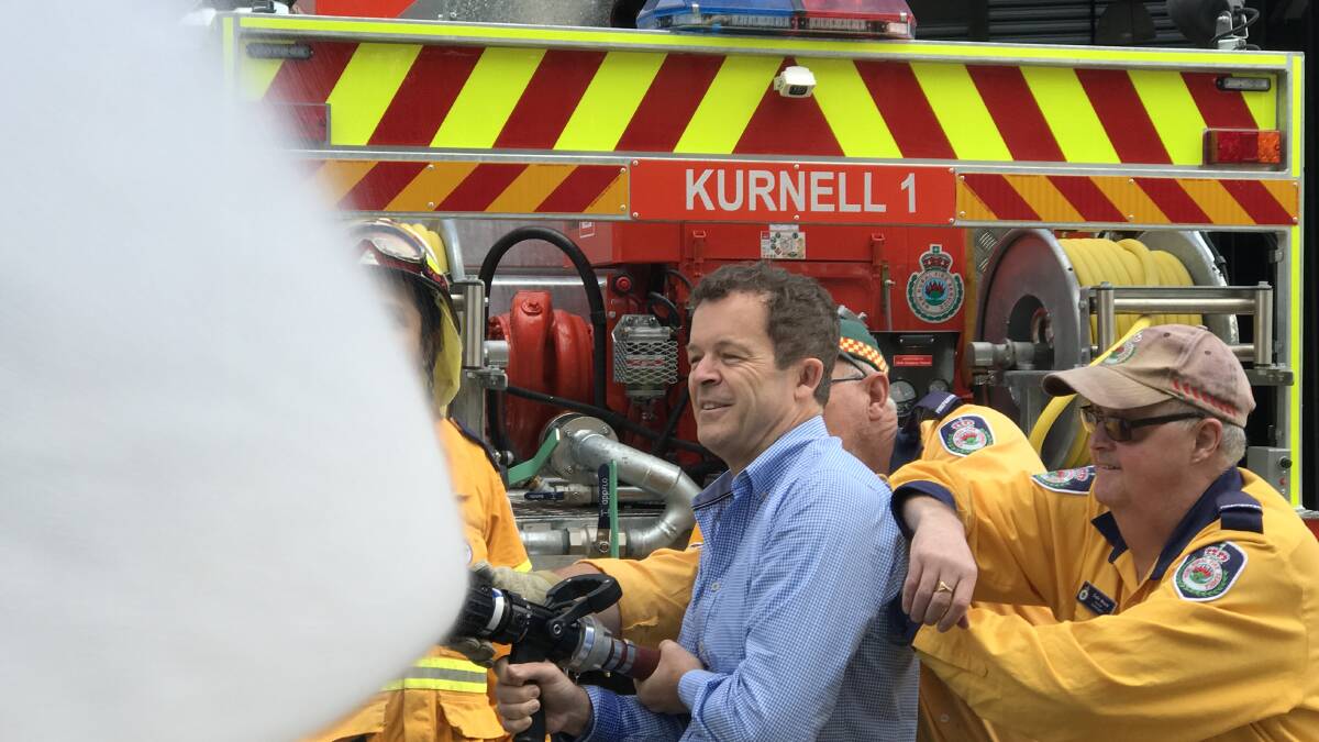 Mark Speakman tries his hand on a hose. Picture: supplied