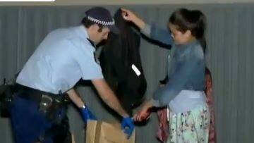 Police remove clothing from the scene of the stabbing at Arncliffe. Picture: 9 News
