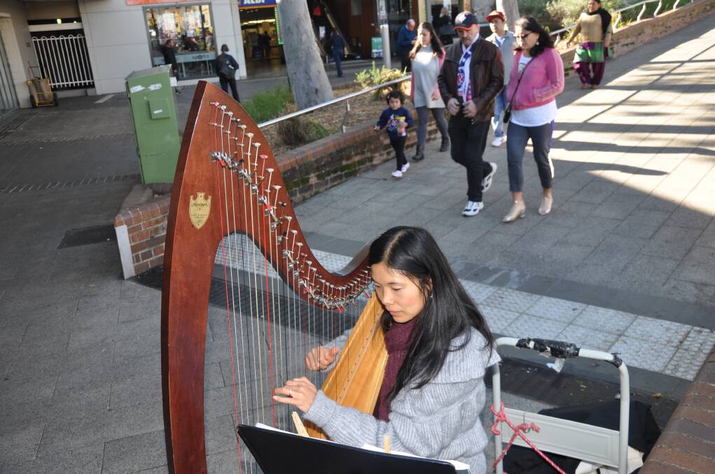 Sweet music: Haruna Thorburn plays outside Kogarah station.