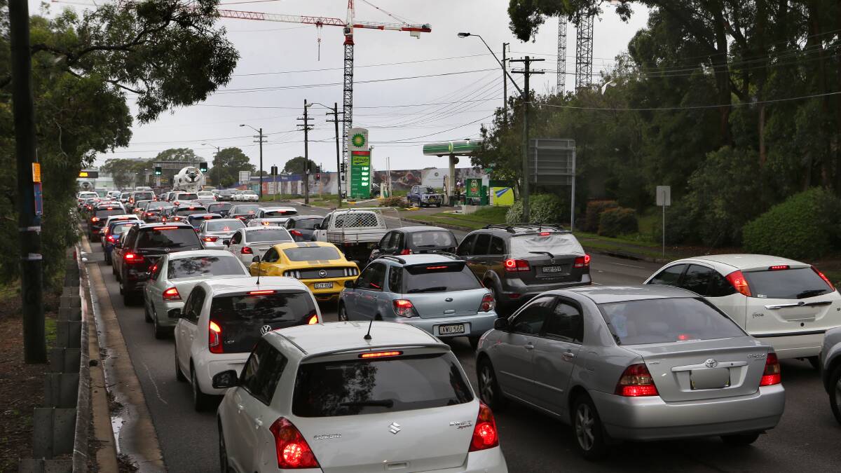 Traffic bottleneck: The morning crawl on Princes Highway towards the intersection of Oak Road, where cranes are working on the South Village development. Picture: John Veage