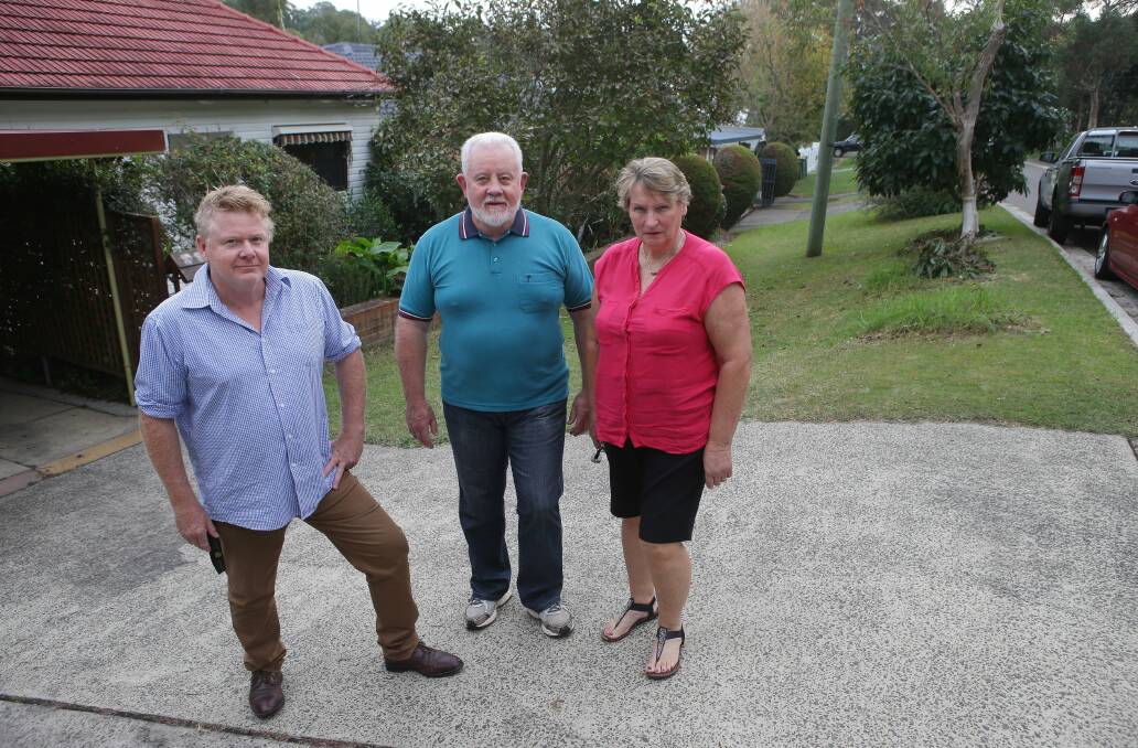 Footpath anger: Craig Sheaves and Kevin and Chris Mackay, who are opposed to plans for a footpath to be constructed in Matson Crescent, Miranda. Picture: John Veage