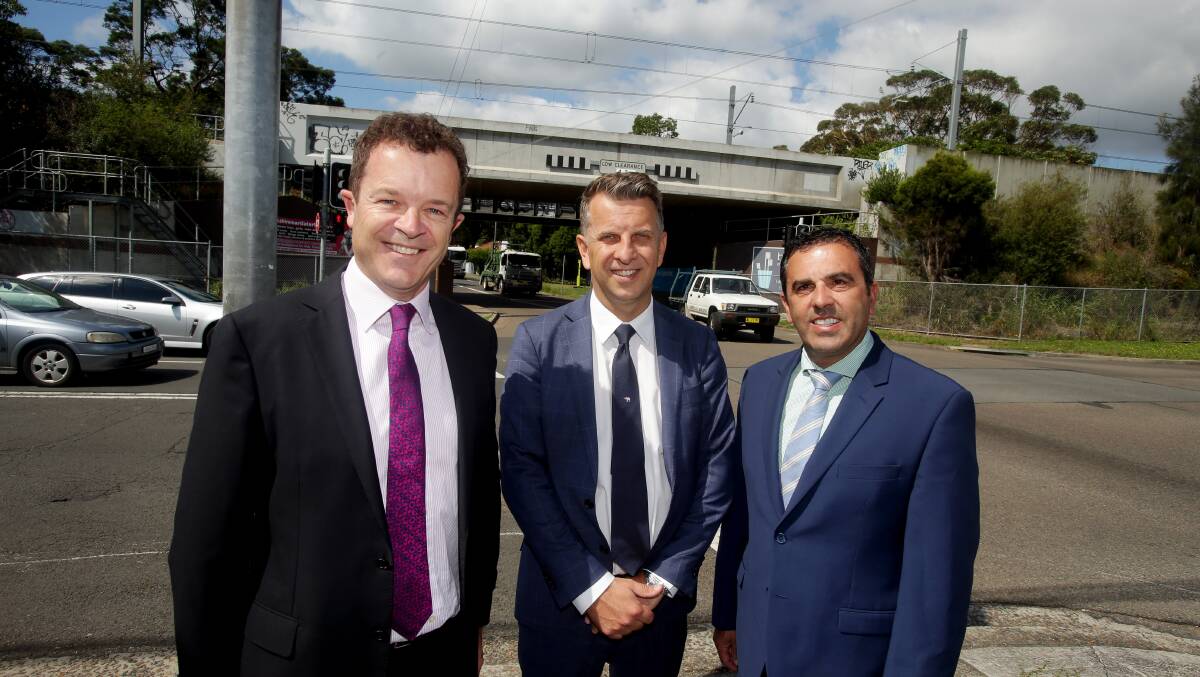 Funds flow: Mark Speakman (left) Andrew Constance and Sutherland Shire mayor Carmelo Pesce in front of the rail underpass. Picture: Chris Lane