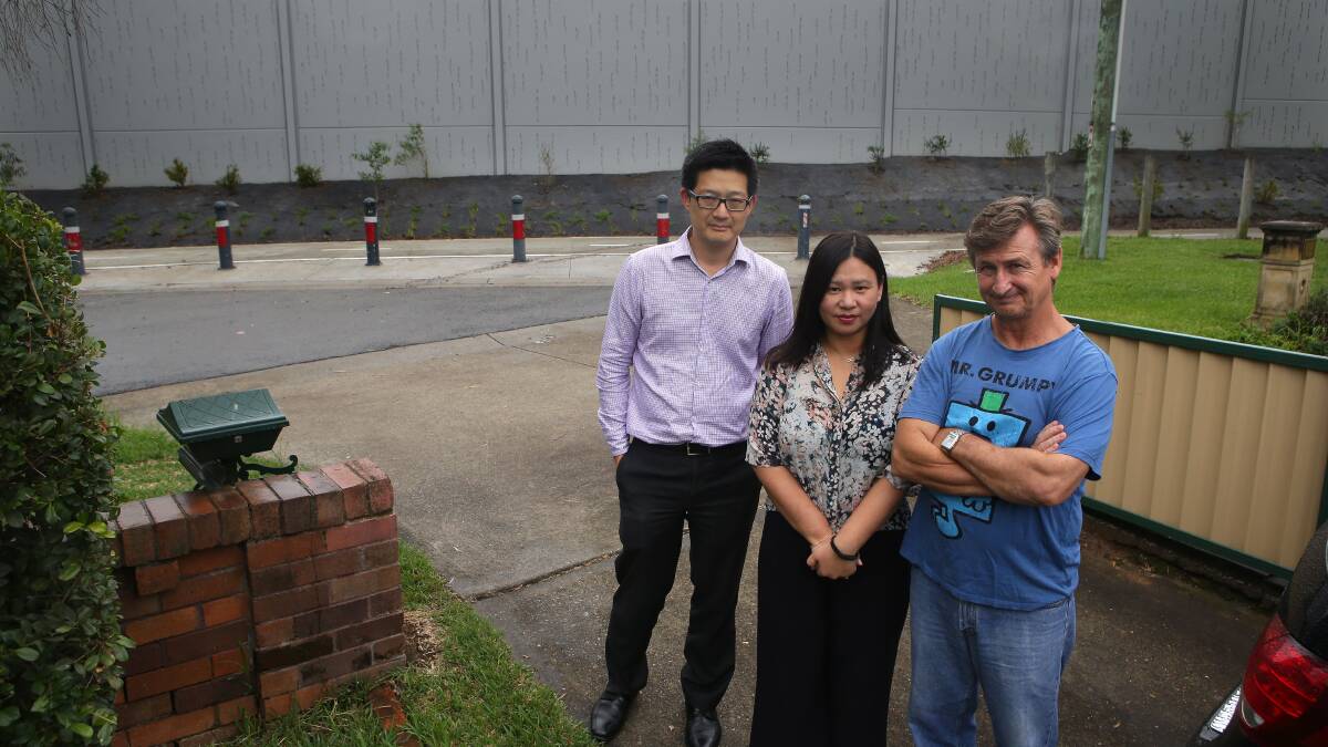 Neighbors, Allen and Christine Wong Wan Po and John English, live 30 metres from where a deep excavation for the King Georges Road interchange took place. Picture: John Veage